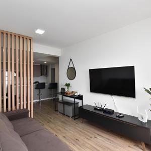 a living room with a flat screen tv on a wall at Apart 1803 - Centro Curitiba in Curitiba