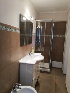 a bathroom with a sink and a shower and a toilet at Candelieri Suites in Sassari