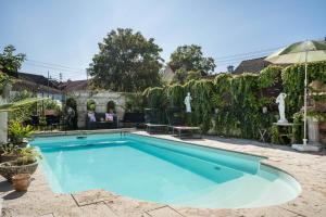 a swimming pool in the backyard of a house at Haus Himmelblick mit privater Sauna in Sasbach am Kaiserstuhl