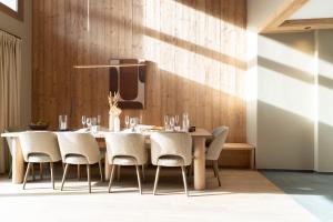 a dining room with a table and chairs at Barma Résidence & Appartements in Courchevel +27 photos