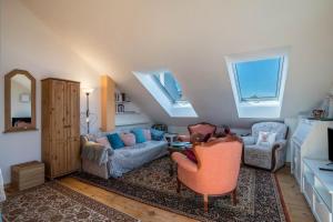 a living room with two chairs and a couch at Haus Himmelblick mit privater Sauna in Sasbach am Kaiserstuhl +18 photos
