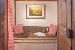 a couch with a book on it in a room at Schwörerhof in Eisenbach