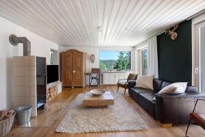 a living room with a couch and a table at Haslehaus in Feldberg