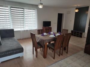 a dining room with a table and chairs and a couch at Miranis in Byala