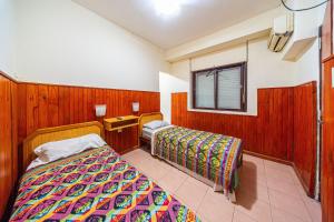 a bedroom with two beds and a window at "Alpha", downtown hotel room in Rosario