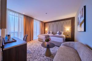 a hotel room with two beds and a table at EDELWEISS HOTEL El Mouradia in El Mouradia