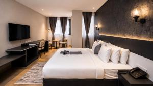 a hotel room with a large bed and a desk at Shitaye Suite Hotel in Addis Ababa