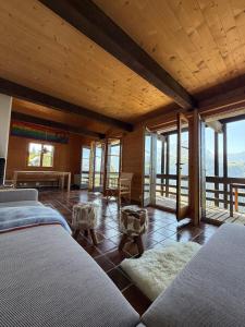 a bedroom with two beds in a room with windows at Beautiful chalet with exceptional views, very quiet in Gryon