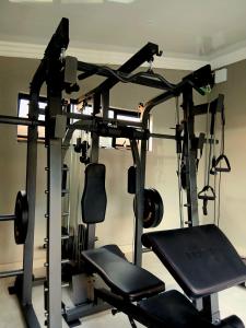 a gym with several tread machines in a room at Impèrio Boutique Guest Lodge in Siyabuswa