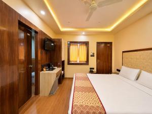 a hotel room with a bed and a sink at Hotel A One Luxury - Premium Stay Puri Beach in Puri +16 photos