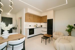 a kitchen and living room with a table and chairs at Aether Home in Ammoudia