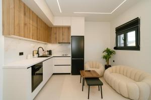 a kitchen with a couch and a table at Aether Home in Ammoudia