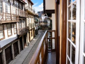 a view from a window of a street with buildings at Guest House Vimaranes in Guimarães