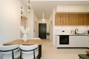 a kitchen and dining room with a table and chairs at Aether Home in Ammoudia