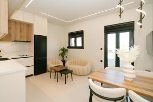 a kitchen and dining room with a table and chairs at Aether Home in Ammoudia