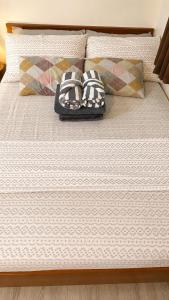 a bed with two pillows on top of it at Nuvali Studio Retreat Free Parking Fast WiFi Pool in Calamba