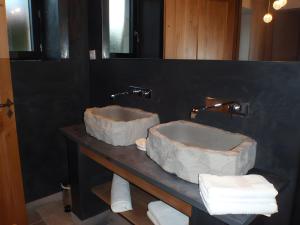 a bathroom with two marble sinks on a counter at Domaine De Jassenove in Millau