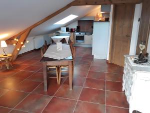 a kitchen with a table and chairs in a room at Domaine De Jassenove in Millau