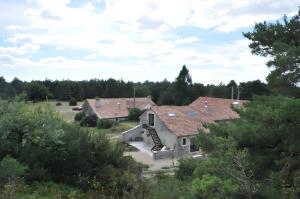 an aerial view of two houses with trees at Domaine De Jassenove in Millau