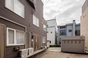 a building with a garage in front of it at つぐ屋札幌 in Sapporo
