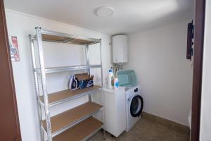 a laundry room with a washer and a washing machine at Esmeralda Guest House in Cinisi