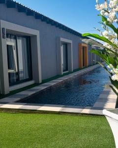 a swimming pool in front of a house at Impèrio Boutique Guest Lodge in Siyabuswa