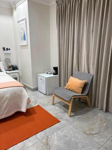a bedroom with a bed and a chair with a pillow at Hotel Dominican Barcelona in SJM +48 photos
