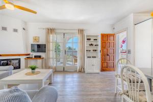 a living room with a couch and a table at Chalet Irene by dracmallorca in Santanyi