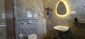 a bathroom with a sink and a shower with a mirror at Villa Riviera in Covelong +57 photos