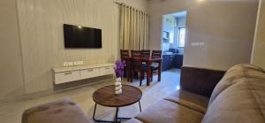 a living room with a couch and a table at Villa Riviera in Covelong