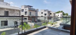 an apartment balcony with a view of buildings at Villa Riviera in Covelong