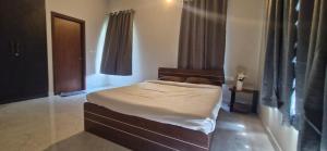 a bedroom with a large bed in a room at Villa Riviera in Covelong