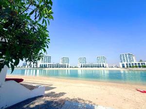 a view of a beach with buildings in the background at Luxury Sea Living in Sharjah
