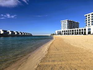 a view of the beach with buildings in the background at Luxury Sea Living in Sharjah +43 photos