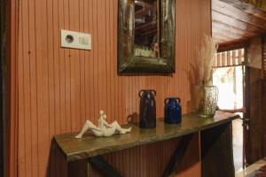 a shelf with vases and statues on a wall at Balian Jus in Tuktuk Siadong