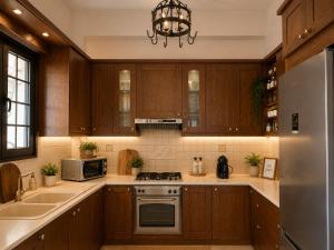 a kitchen with wooden cabinets and a stove top oven at Stagiates House in Stagiates