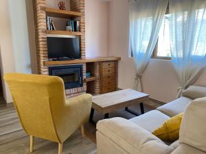 a living room with a couch and a tv at R2R - Apartamentos Prellezo - C20C03 in Prellezo