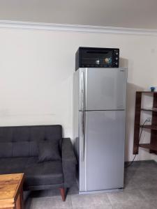 a living room with a refrigerator and a couch at Arami Guest House in Dilijan