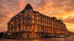 a large building with cars parked in front of it at Hotel Central in Ploieşti