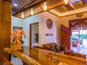 a living room with a table and a couch at Griya Mandara Homestay Prambanan in Bugisan +19 photos