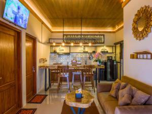 a living room with a couch and a dining room at Griya Mandara Homestay Prambanan in Bugisan