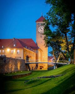 a large building with a clock tower on top of it at Apartament centrum Szczytno Mazury in Szczytno