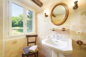 a bathroom with a sink and a mirror and a window at Chez Jeanne, superbe corps de ferme, vue imprenable in Issor +72 photos