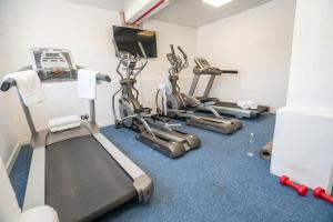 a gym with cardio machines and a flat screen tv at Budget En-suite Room in Coventry City Centre in Coventry