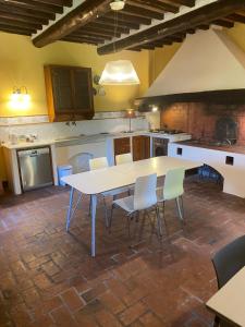 a kitchen with a table and chairs in a room at il MOLENDINO in Calci