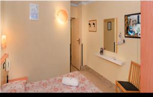 a small room with a bed and a bathroom at Storyville Simple Stay - Special Offers in Cinquale
