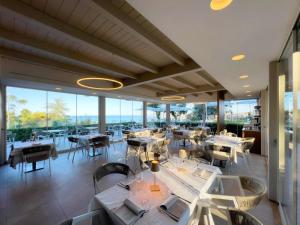 a restaurant with tables and chairs and large windows at Bluonly Boutique B&B in Vasto