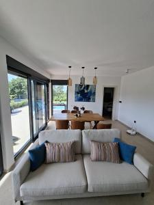 a living room with a couch and a table at Vila Mila Private Pool Retreat in Radetići
