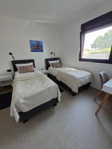a bedroom with two beds and a window at Vila Mila Private Pool Retreat in Radetići +54 photos