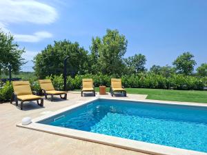 a swimming pool with lounge chairs and chairs next to it at Vila Mila Private Pool Retreat in Radetići